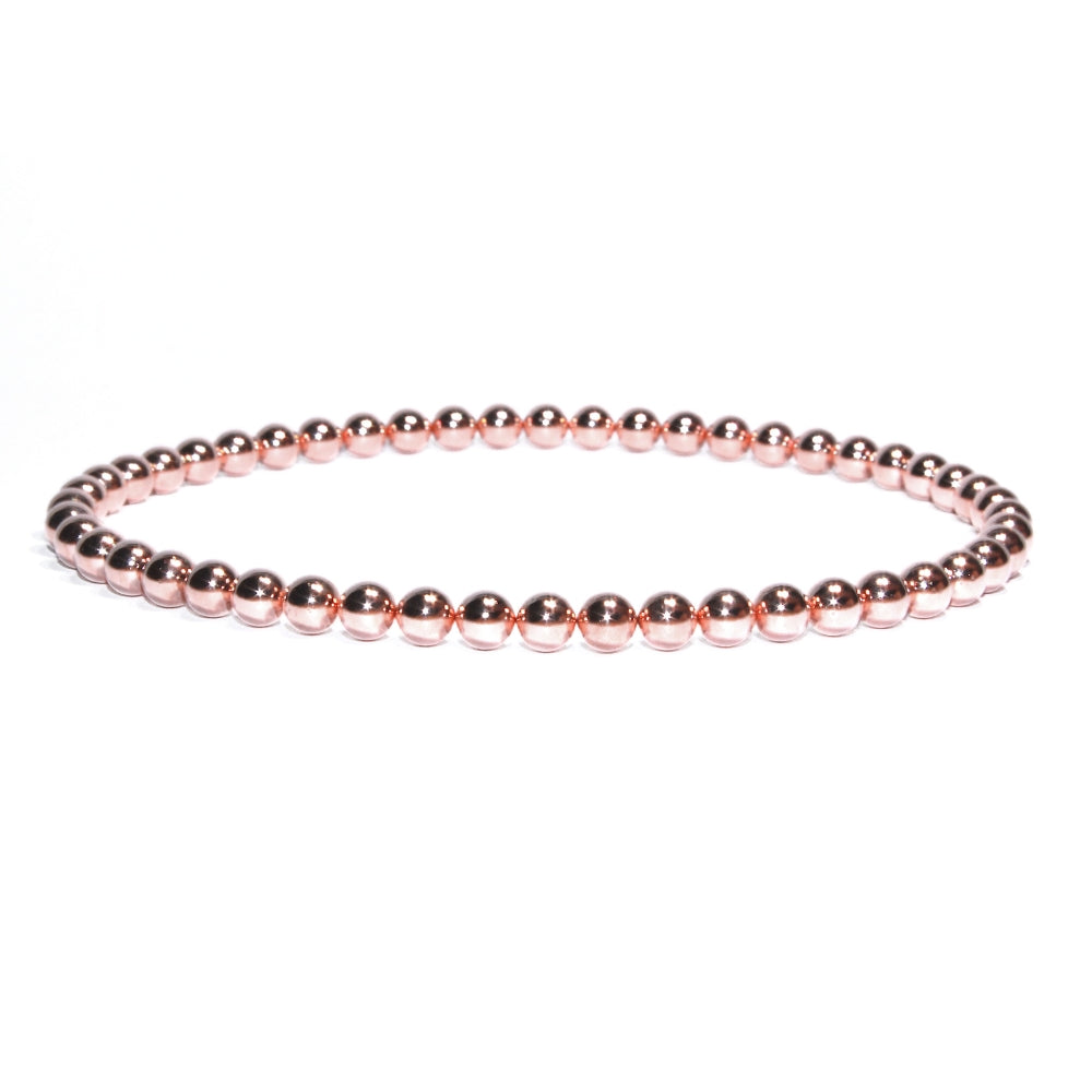 Photo sur fond blanc du bracelet de cheville en pierre d'aimant naturelle composé de perles roses.